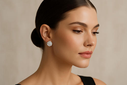Premium image of a model with hair styled back to showcase lab-grown diamond earrings. The earrings should sparkle naturally with perfect clarity and reflection. Background in soft beige or off-white tones with gentle shadows for depth. Luxury, simple, and modern aesthetic