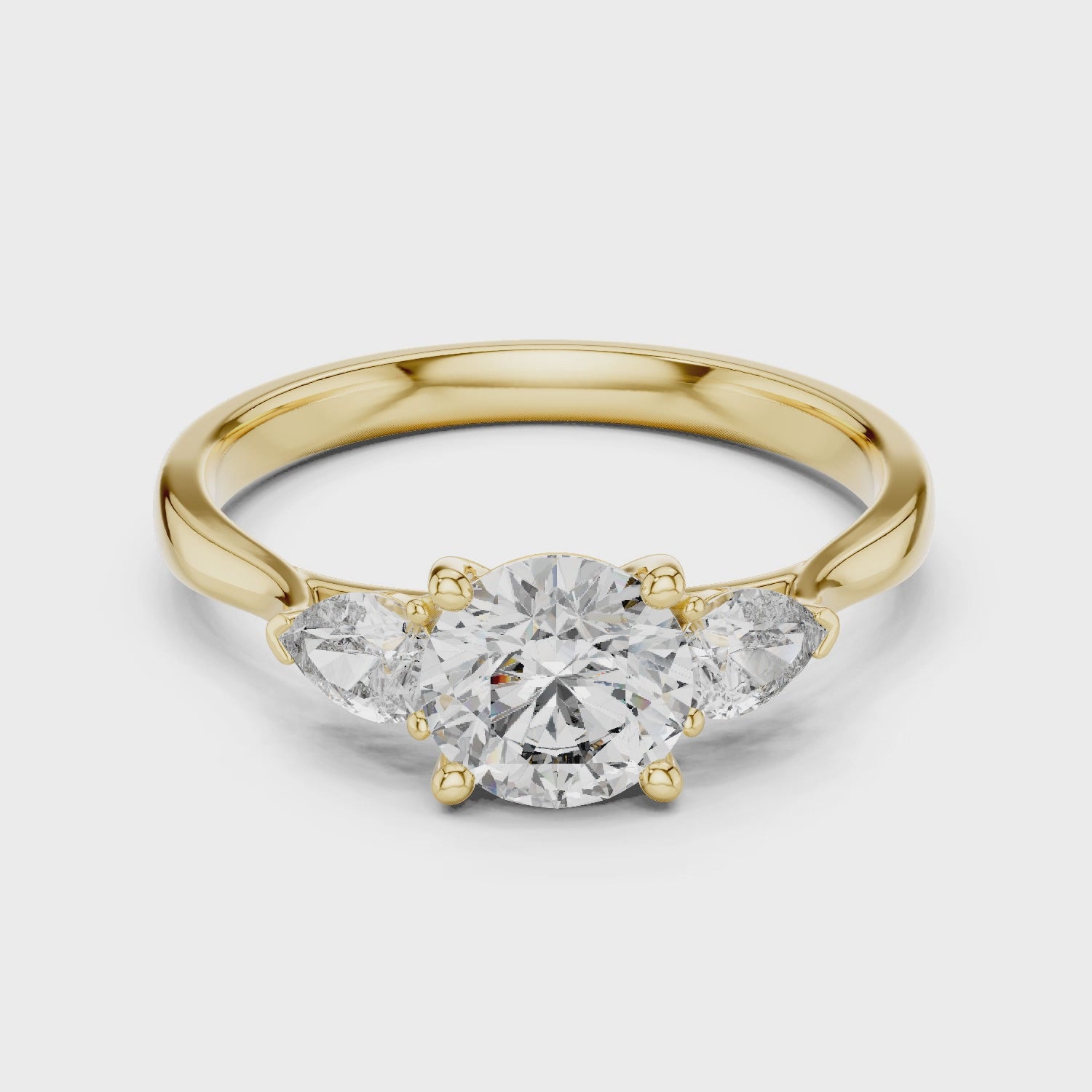 Round and Pear Diamond Three Stone Ring